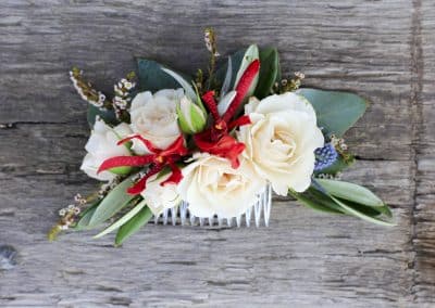 Hairclip for a bride that includes ivory mini roses, burgundy orchids, thistle, heather, eucalyptus.